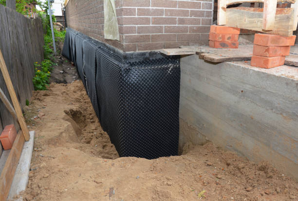 Happy homeowners after waterproofing job in Hubertus